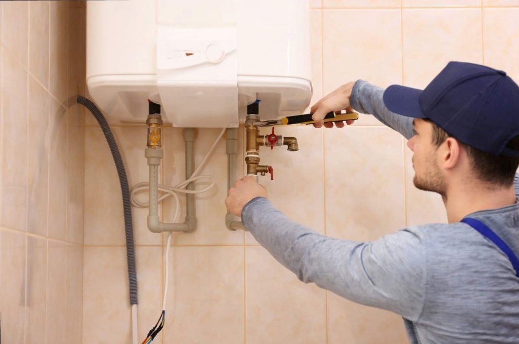 depositphotos-147562951-stock-photo-plumber-repairing-boiler-in-bathroom-transformed